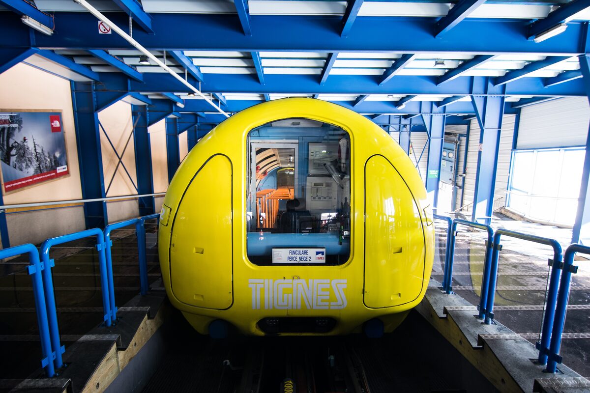 The yellow Perce-Neige funicular car waiting in its station in Tignes