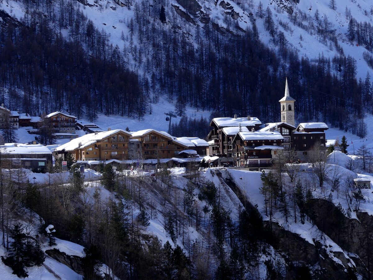 Tignes 1800 perched on a snowy hillside, its church tower rising above the chalets