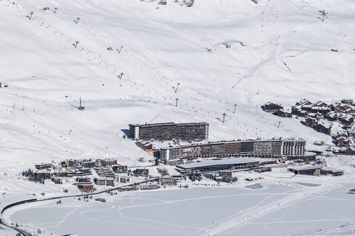 Tignes Le Lac in winter, with hotel blocks above the lake under snow