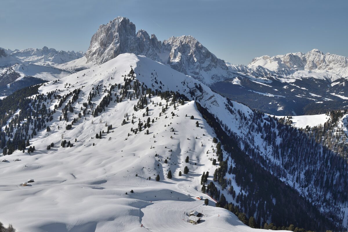 Snowy slopes and larch forest below the Mastlè and Pic peaks, the mountain area around the Curona Hut