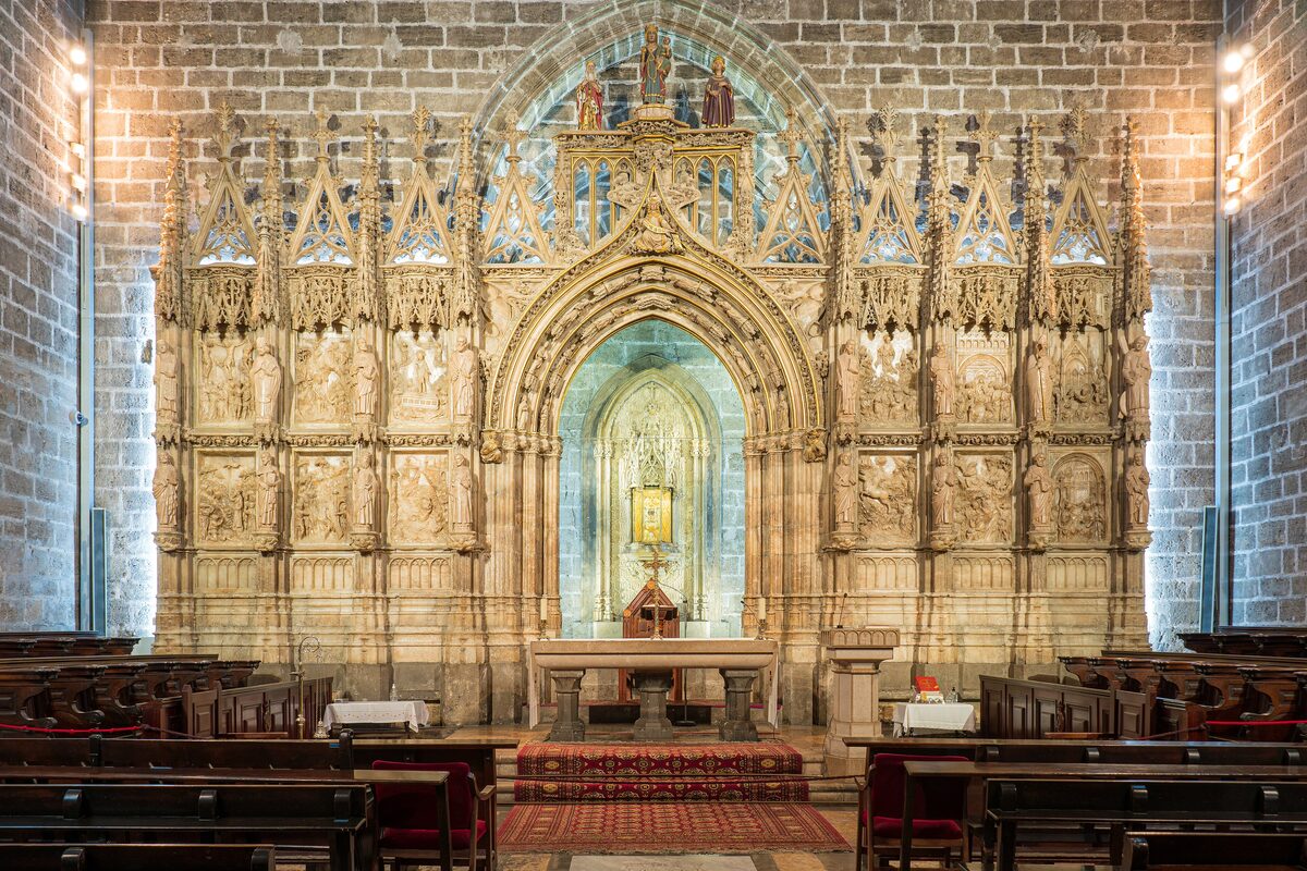 The Holy Chalice chapel in Valencia Cathedral, a Gothic stone altarpiece with the chalice displayed in a glowing niche
