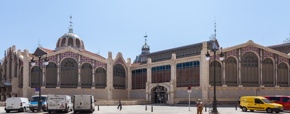 The long Modernist facade of the Mercado Central in Valencia, with its domes, ironwork and colored glass