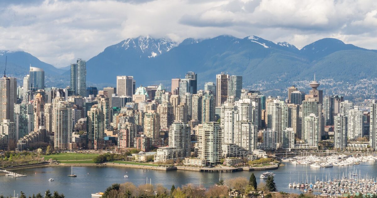 The Vancouver skyline across Burrard Inlet with the snow-covered North Shore mountains behind it