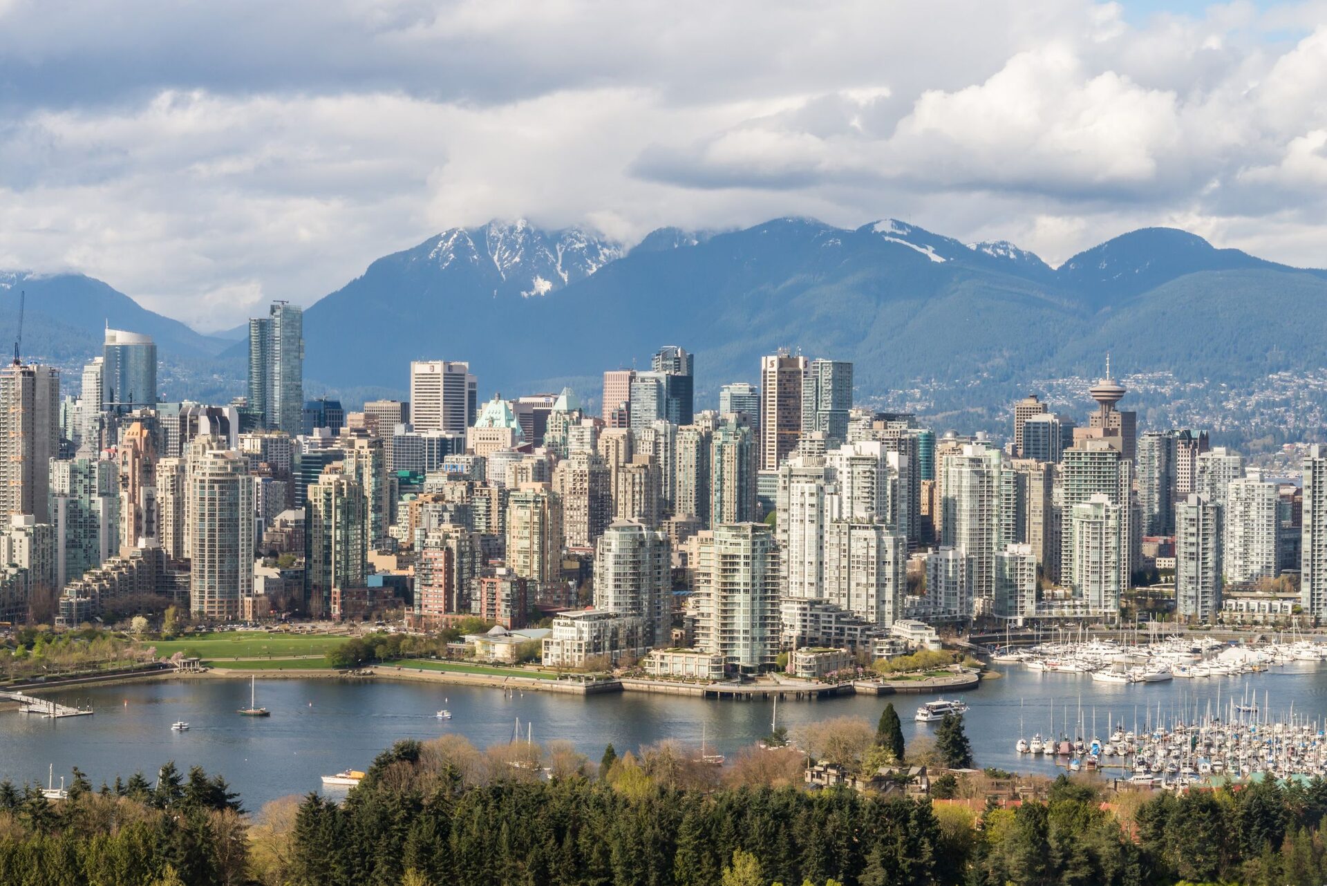 The Vancouver skyline across Burrard Inlet with the snow-covered North Shore mountains behind it