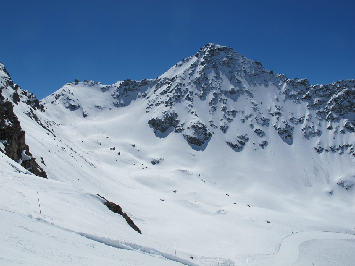 The snowy pyramid of the Bec des Rosses above a steep white bowl