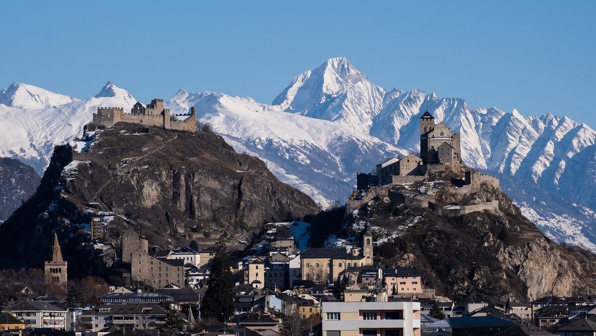 Sion in winter, with the castles of Valère and Tourbillon on their rocky hills above the old town and snowy peaks behind