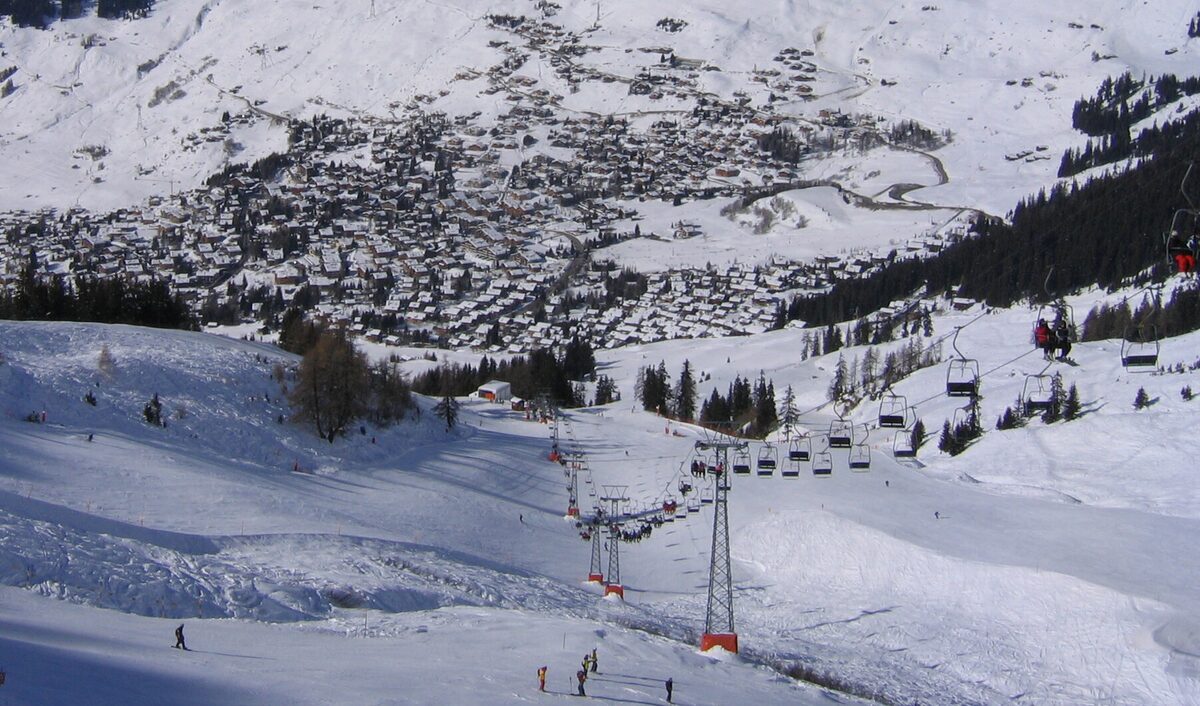 The village of Verbier under snow, with chairlifts and pistes on the slopes above the houses