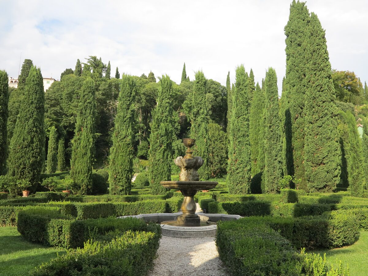 The Italian garden of Giardino Giusti, a fountain among clipped hedges and cypresses