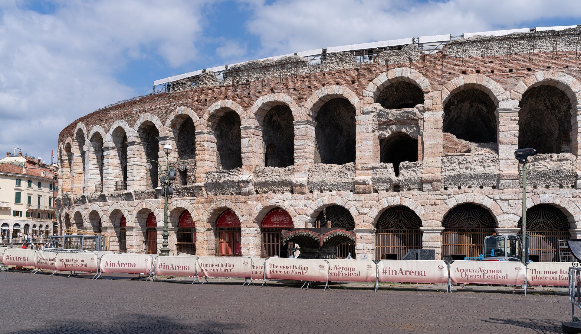 The Roman Arena in Verona seen from Piazza Bra, its stone arches in full sun