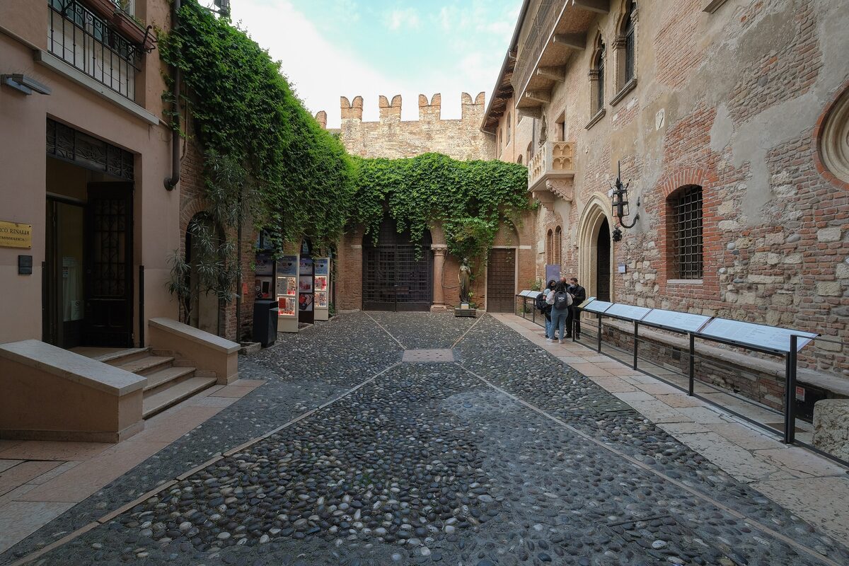 The ivy-covered courtyard of Juliet's House with the balcony on the right