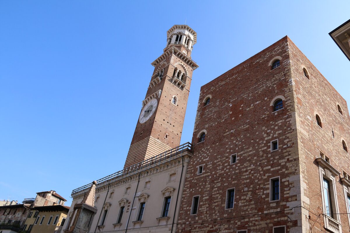 The brick and stone Lamberti Tower with its clock above the Palazzo della Ragione