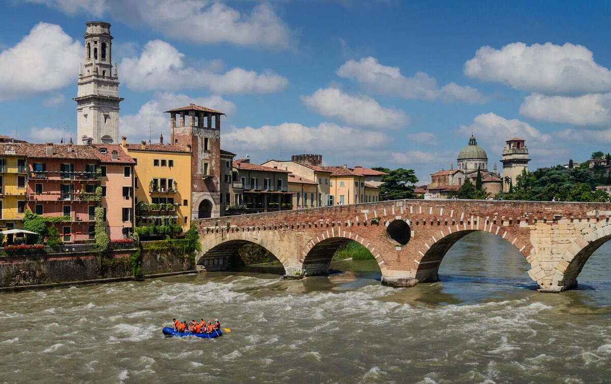 The arches of Ponte Pietra over the Adige with the cathedral tower behind