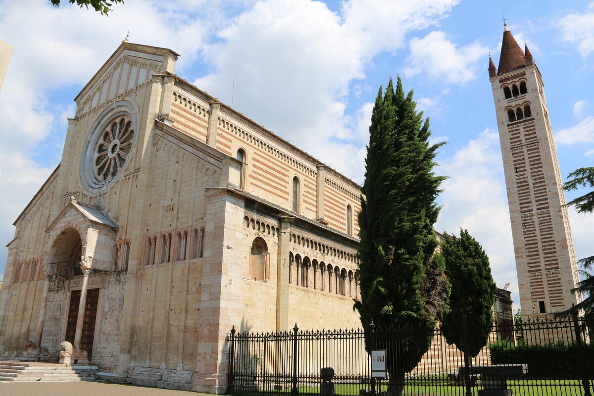The striped Romanesque facade and tall campanile of San Zeno, seen from the side