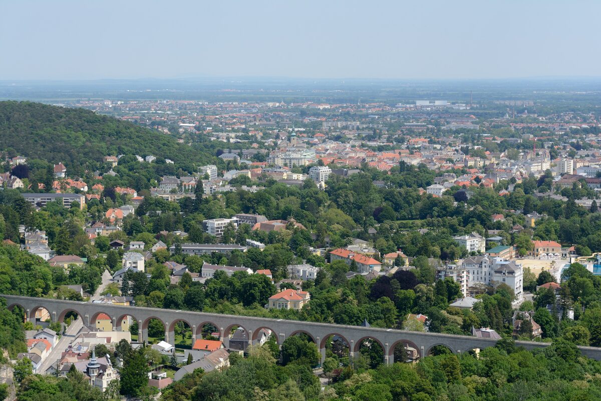 View over the spa town of Baden bei Wien from the hills, with the railway viaduct in front and the plain beyond