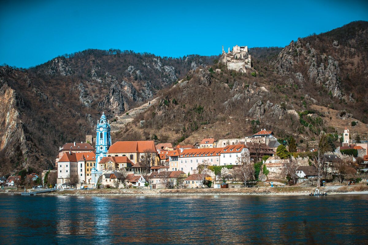 Dürnstein on the Danube, with the blue and white baroque abbey tower by the water and the castle ruin on the rocky hill above