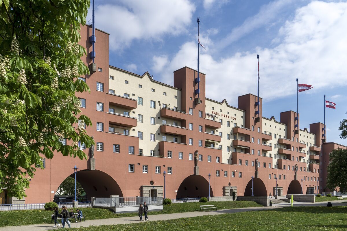 The long red and ochre facade of the Karl-Marx-Hof with its great arches and flagpole towers