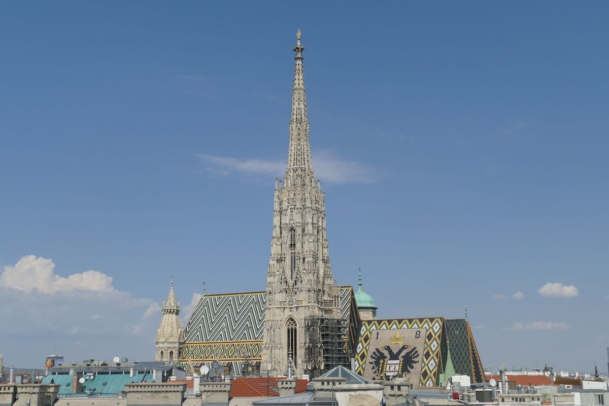 St. Stephen's Cathedral in Vienna with its Gothic south tower and patterned tiled roof under a blue sky