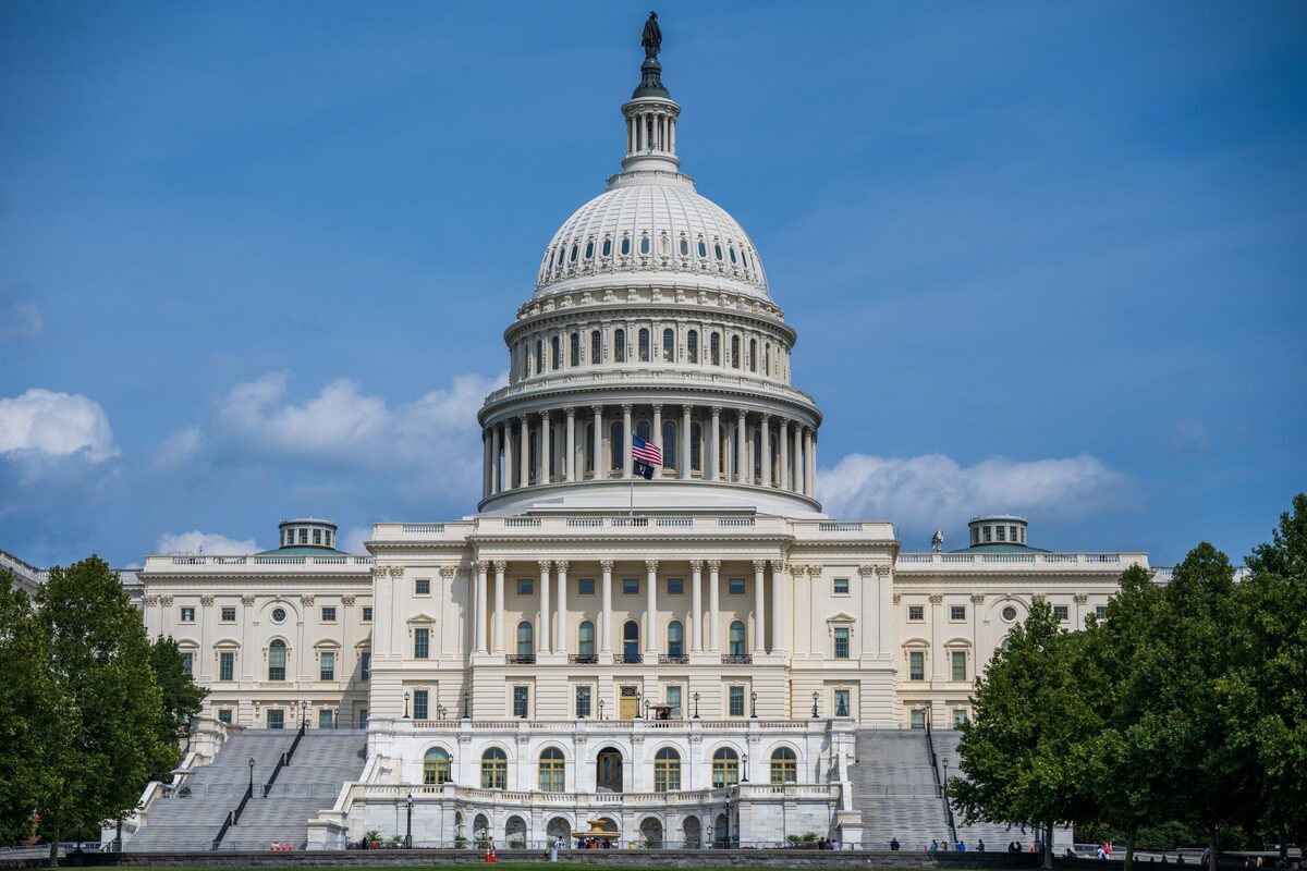 The Capitol dome and west front under a blue sky