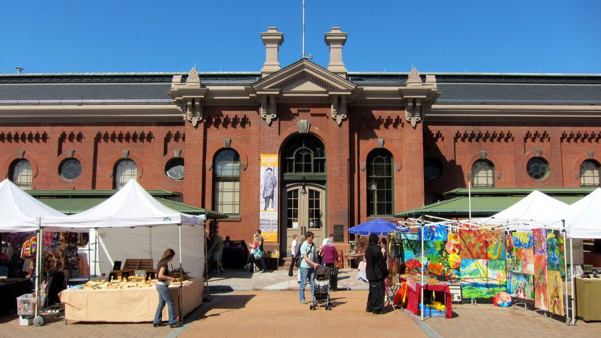 Red-brick Eastern Market hall with craft stalls in front
