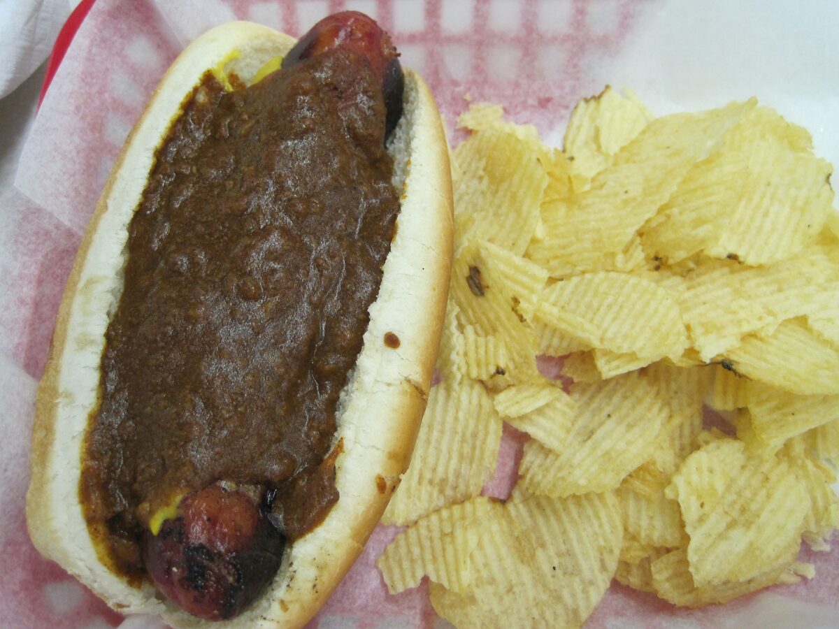 A chili half-smoke in a bun with potato chips