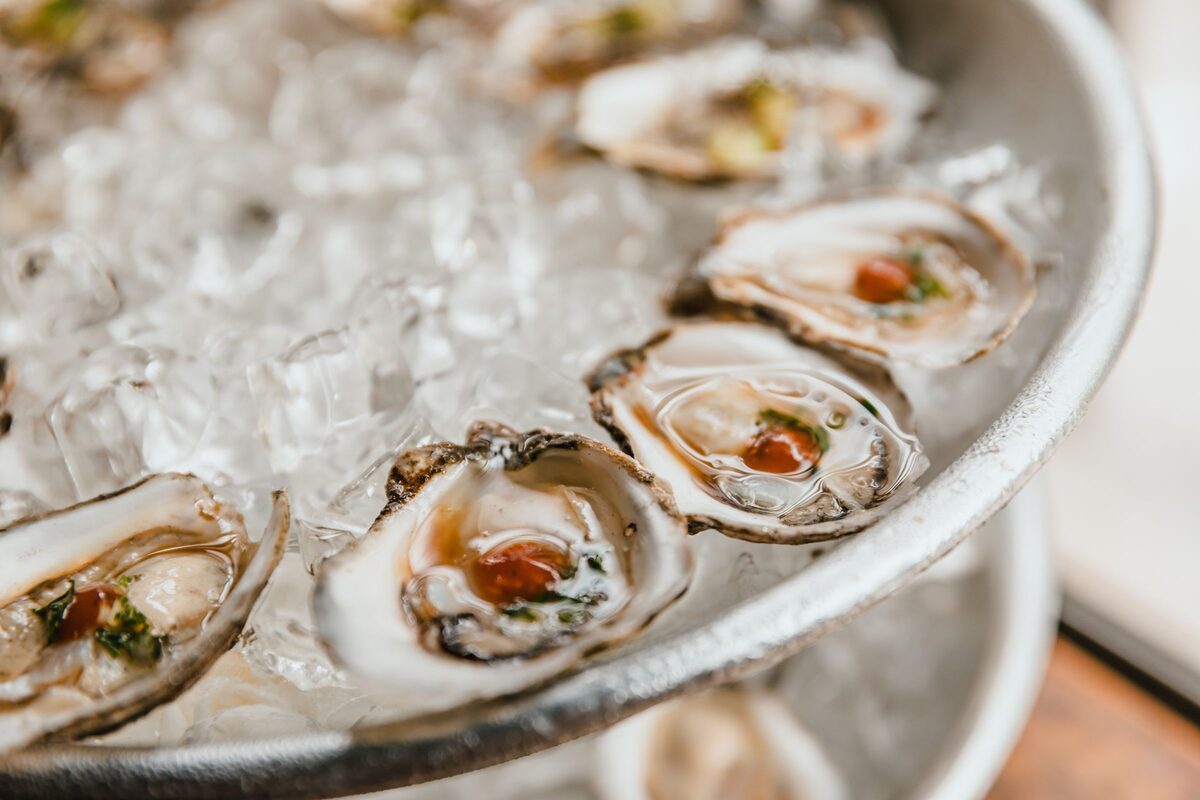 Raw oysters on crushed ice with lemon and sauce