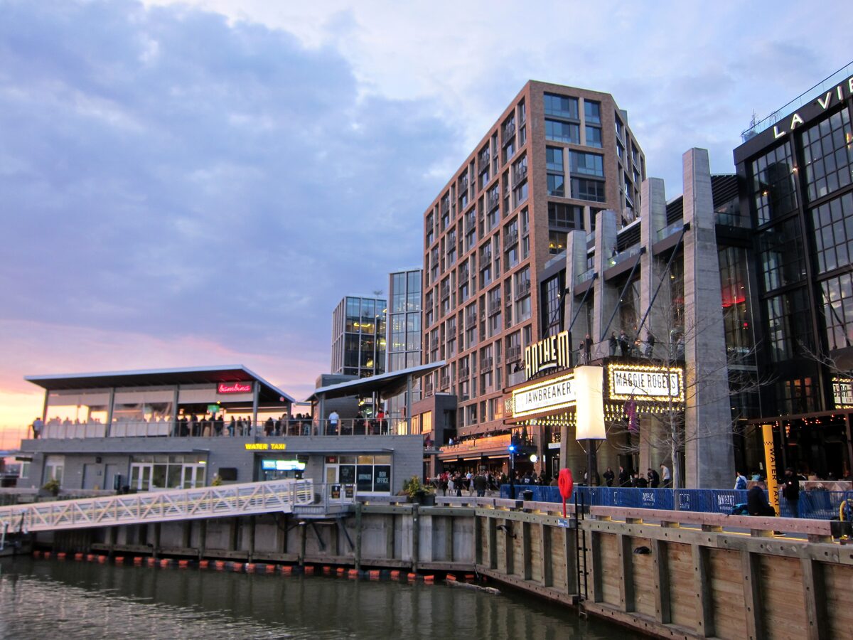 Waterfront buildings and boardwalk at The Wharf at dusk
