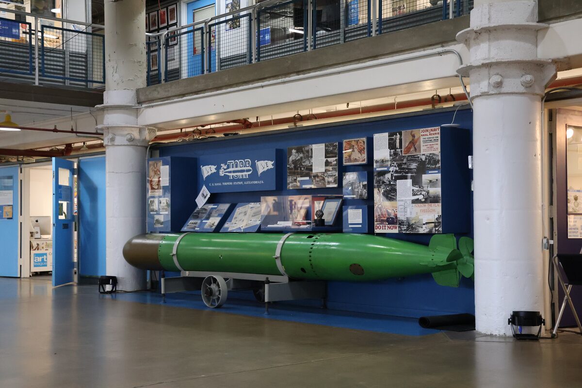 Exhibit hall with a green torpedo inside the Torpedo Factory