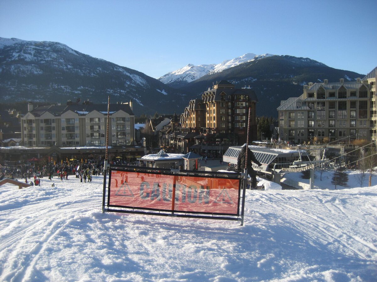 Whistler Village buildings above the snow-covered base area with the mountains behind