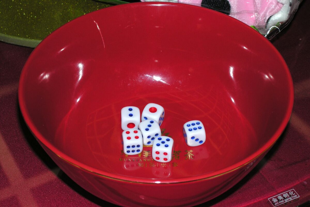 Six dice in a red bowl, the set used for the Mid-Autumn bobing dice game