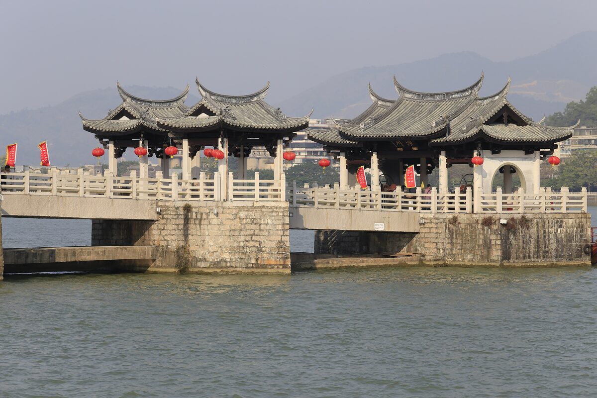 The roofed pavilions on the stone piers of Guangji Bridge over the river in Chaozhou