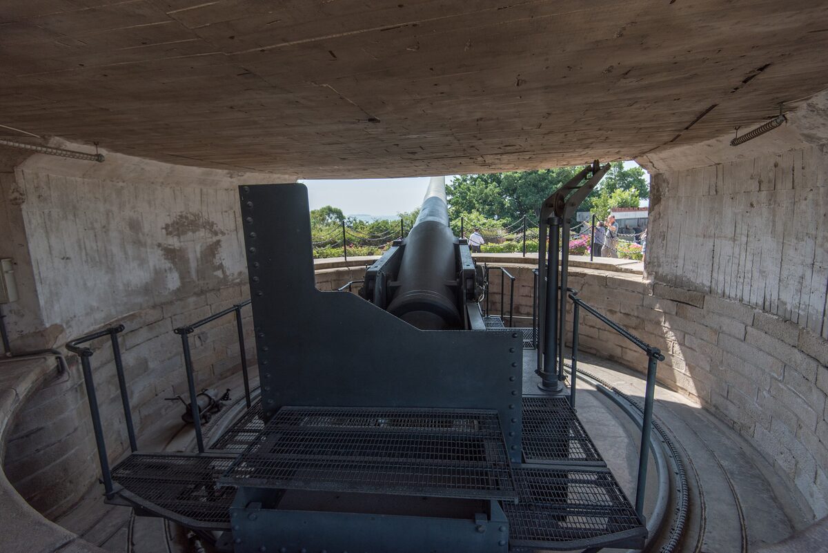 A heavy coastal gun in its round concrete emplacement at Hulishan Fortress