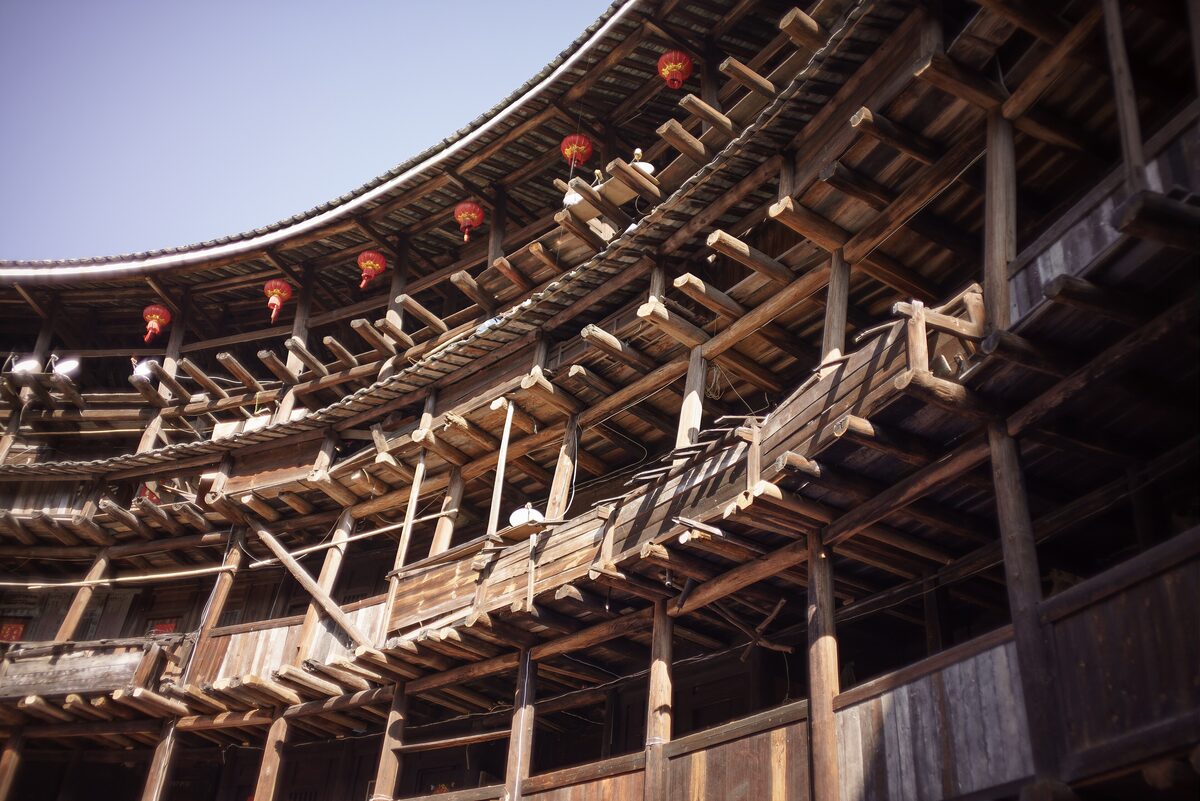 Inside Yuchang Lou, with wooden galleries rising in rings around the courtyard and red lanterns hanging
