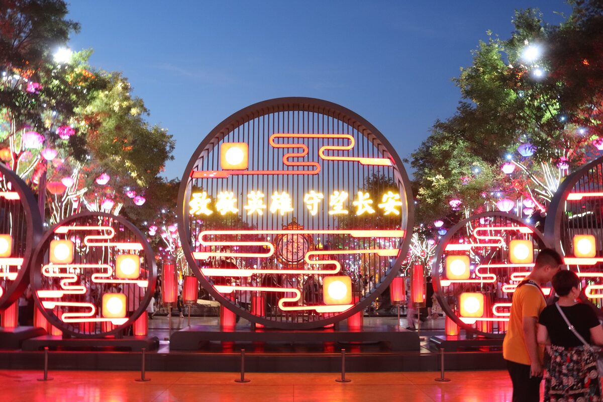 A glowing circular lantern installation with Chinese characters at Datang Everbright City at dusk