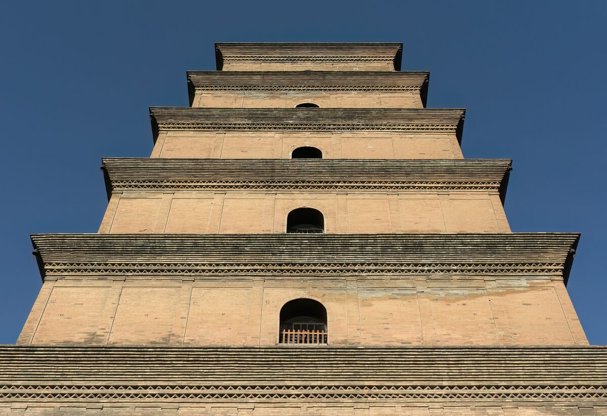 The stepped brick tiers of the Big Wild Goose Pagoda against a deep blue sky