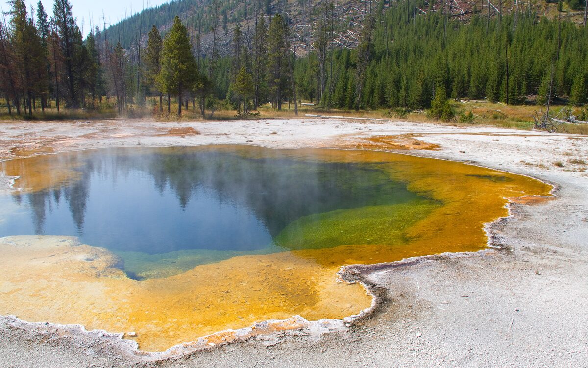 Rainbow Pool at Black Sand Basin, orange rim around blue water