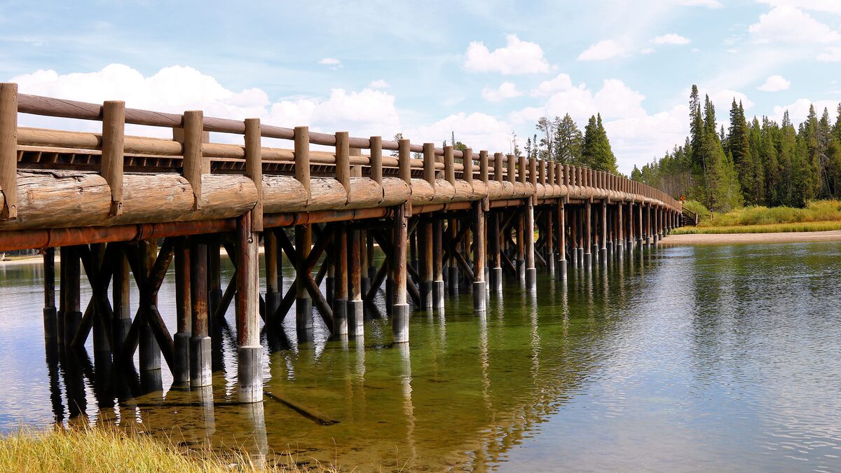 Fishing Bridge's wooden railing curving across the Yellowstone River