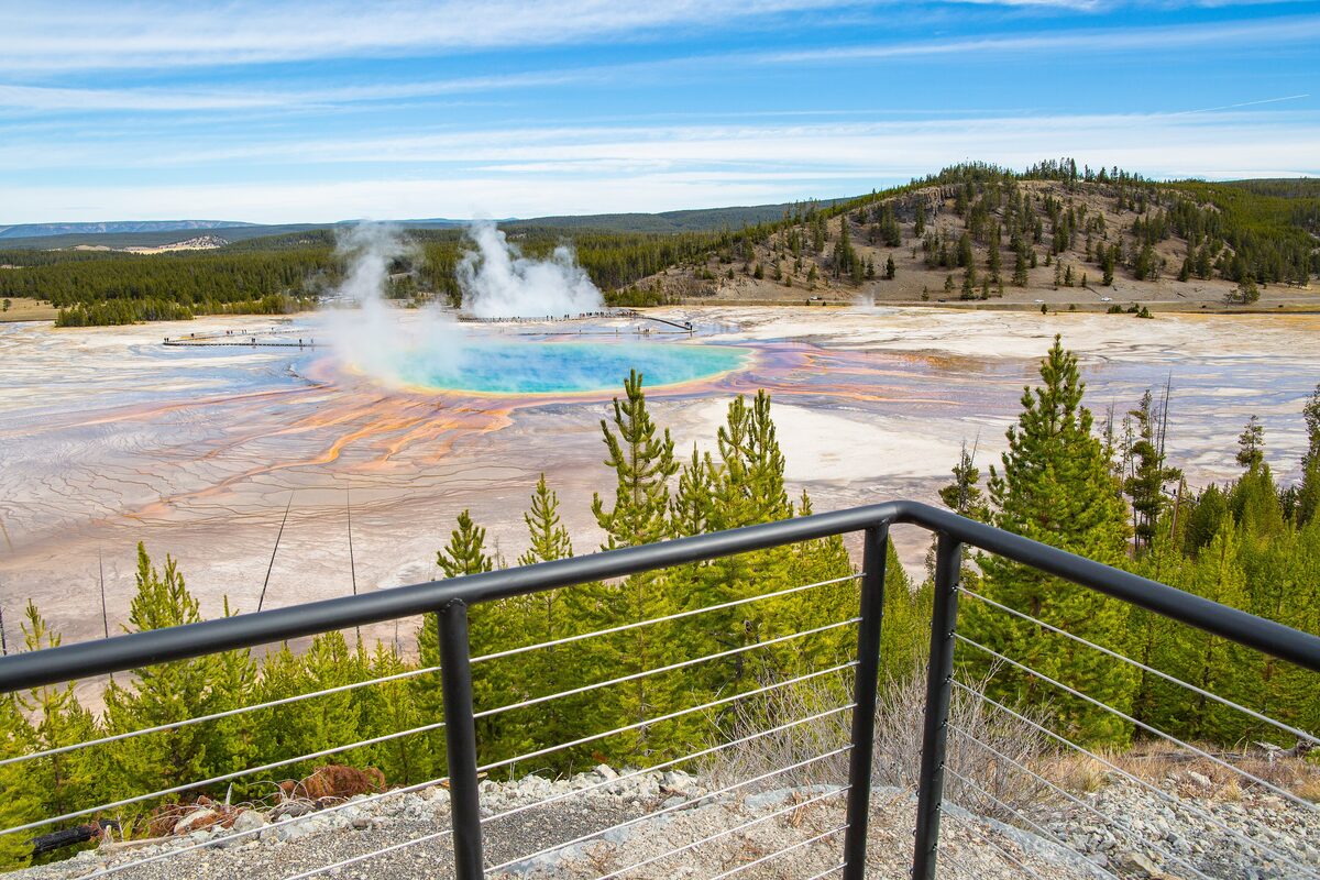 Grand Prismatic Spring steaming beyond the overlook trail's railing