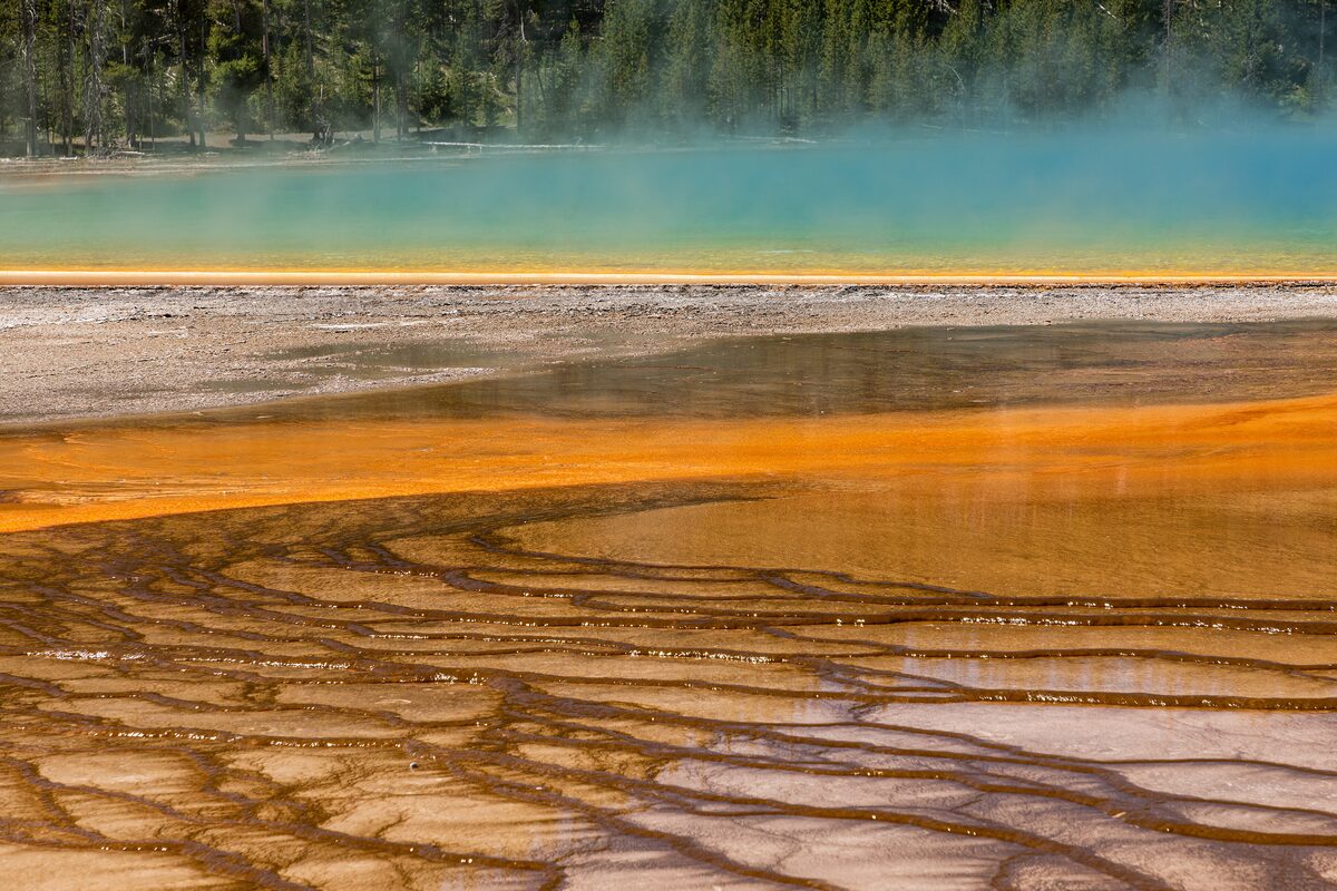 Orange runoff channels fanning toward Grand Prismatic Spring's blue edge