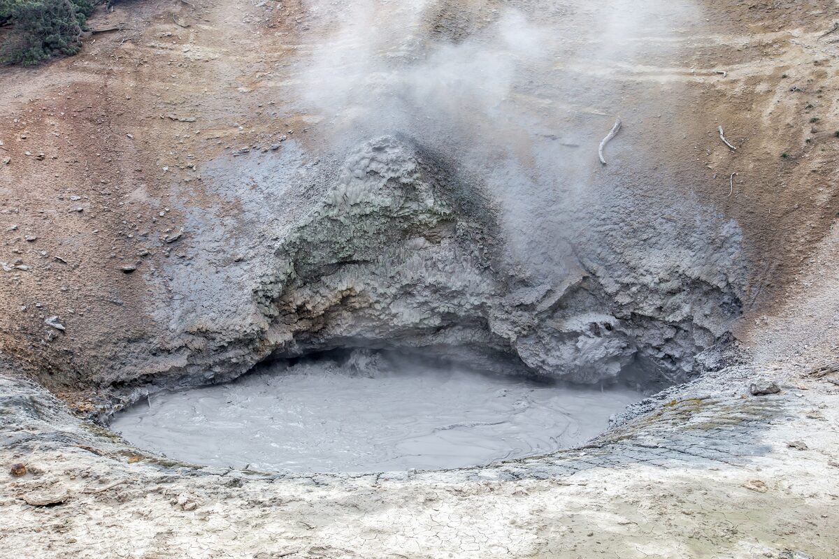 Steaming gray mud bubbling in the Mud Volcano crater