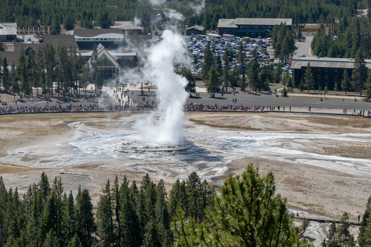 Old Faithful erupting below, seen from the Observation Point ridge