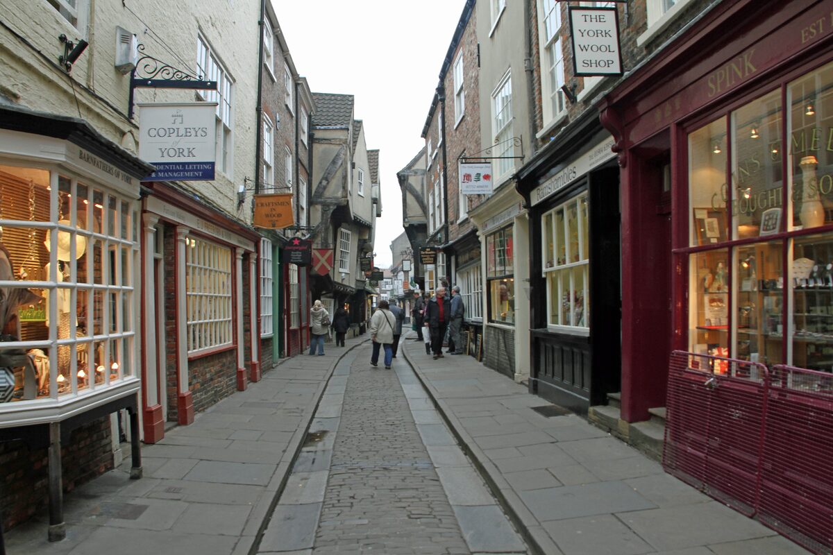 The narrow medieval Shambles in York, with timber-framed houses leaning over the cobbled street