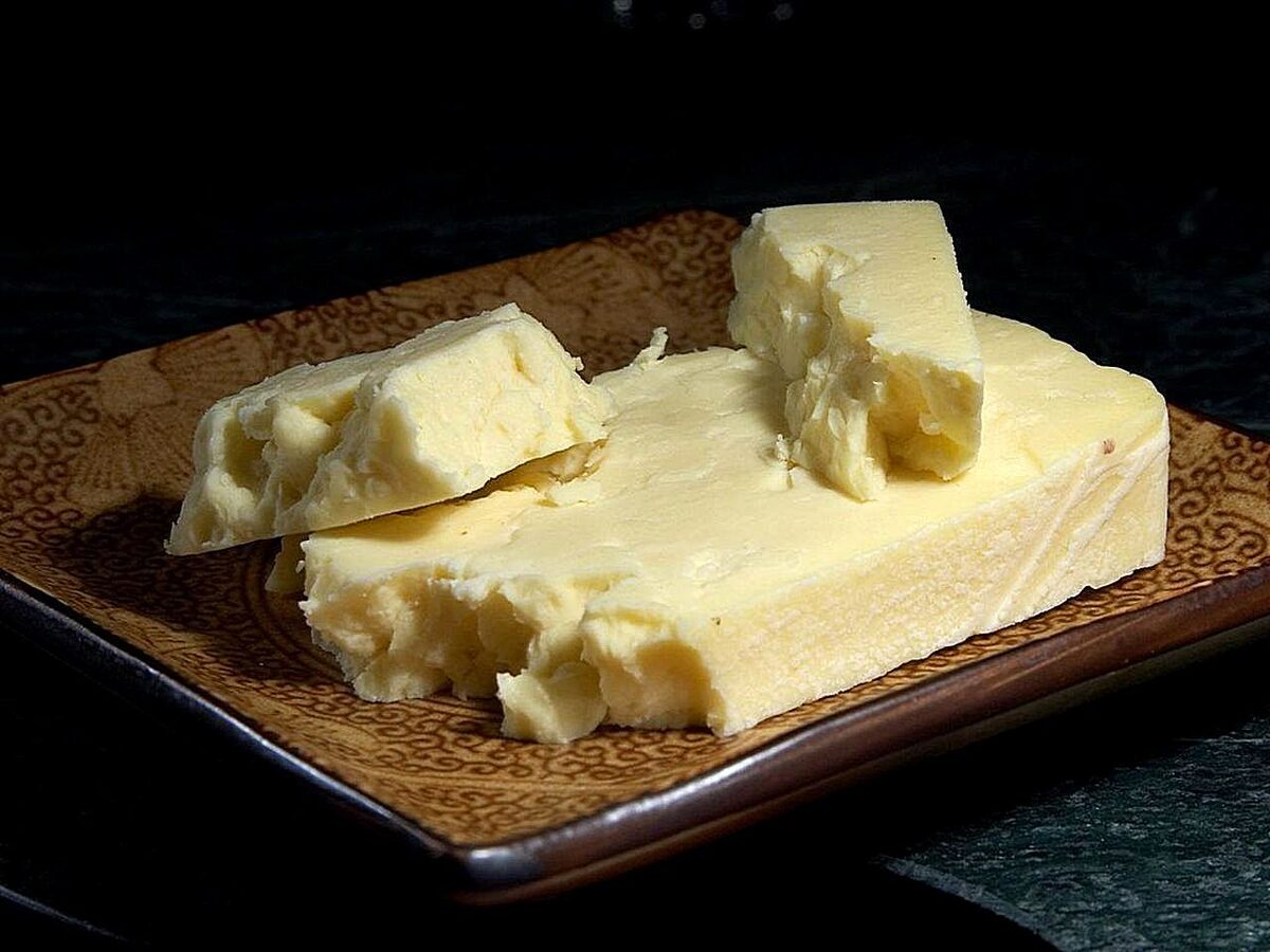 Chunks of crumbly white Wensleydale cheese on a brown plate