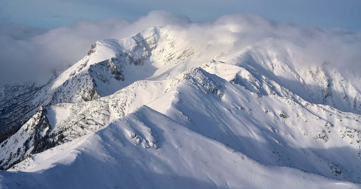 Snow-covered Tatra ridges under drifting cloud on a winter day, the Kasprowy Wierch side of the range