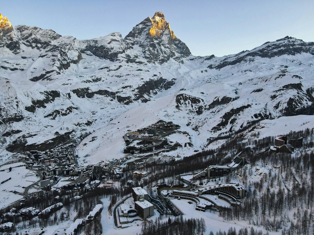 Breuil-Cervinia and its ski slopes under fresh snow, with the Matterhorn catching early light above