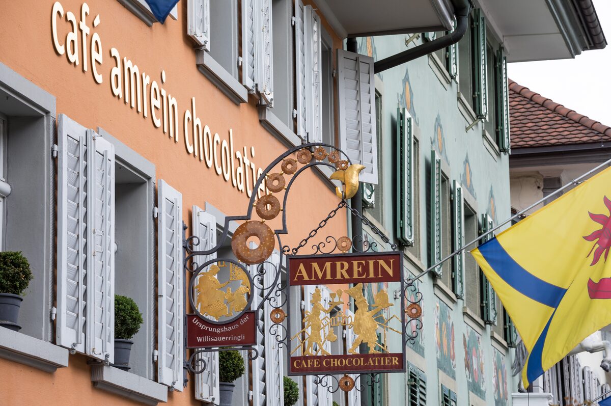 A chocolatier's hanging sign and painted facade in Willisau, one of the old Swiss chocolate shops, not in Zermatt