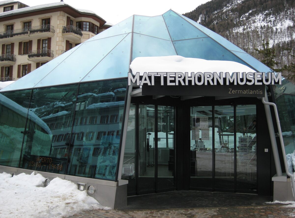 The glass pyramid entrance of the Matterhorn Museum on Kirchplatz with winter snow on its edge