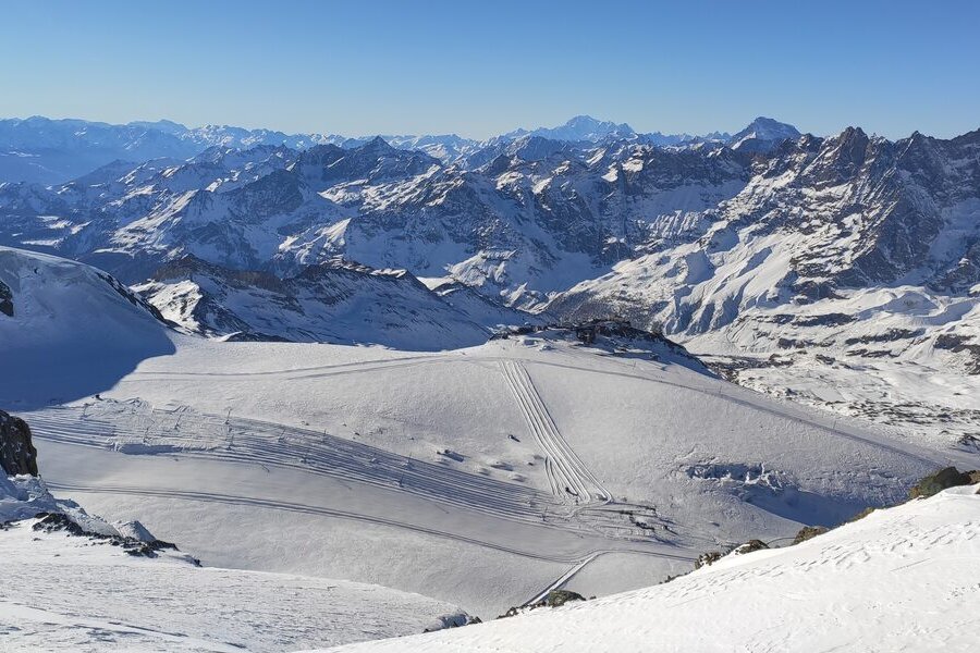 The wide white Theodul glacier ski area at Plateau Rosa in January, with snowy peaks beyond
