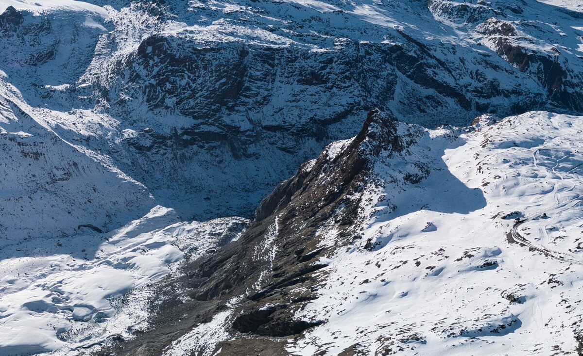 A rocky ridge beside the Gornergletscher glacier in winter, seen from the Gornergrat side above Rotenboden