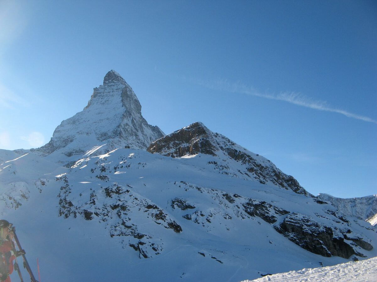 The snow-covered Matterhorn seen from Schwarzsee under a blue winter sky