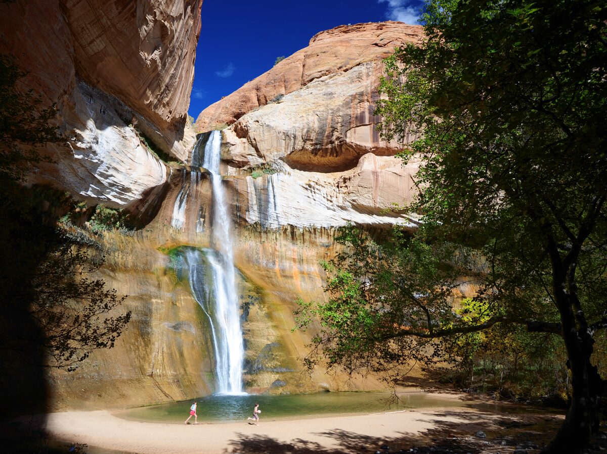 Lower Calf Creek Falls dropping into a pool below the cliffs
